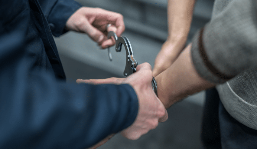 police officer cuffing a person under arrest